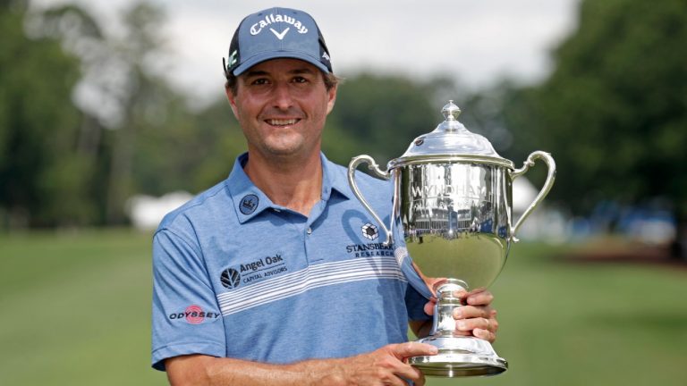 Kevin Kisner poses with the trophy after he sunk a birdie putt on the second playoff hole to win the Wyndham Championship golf tournament at Sedgefield Country Club in Greensboro, N.C., Sunday, Aug. 15, 2021. (Chris Seward/AP)