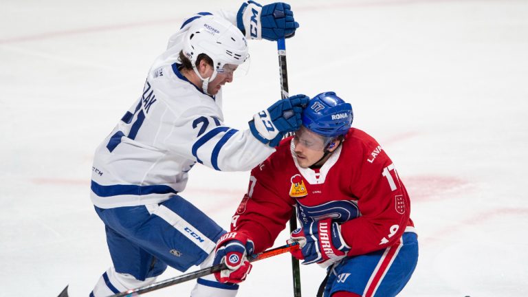 Laval Rocket's Brendan Gallagher, right, is checked by Toronto Marlies' Joseph Duszak during first period American Hockey League action in Montreal, Monday, May 17, 2021. Carey Price and Brendan Gallagher are on a one game conditioning loan to the Rocket before the start of their playoff series against the Toronto Maple Leafs. (Ryan Remiorz/CP) 
