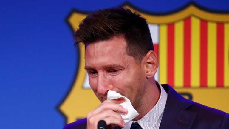 Lionel Messi cries at the start of a press conference at the Camp Nou stadium in Barcelona, Spain, Sunday, Aug. 8, 2021. FC Barcelona had previously announced the negotiations with Lionel Messi had ended and that Messi would be leaving the club. (Joan Monfort/AP) 
