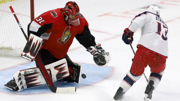 Ottawa Senators goaltender Anders Nilsson (31) stops Columbus Blue Jackets right wing Cam Atkinson (13) during overtime NHL action in Ottawa, Saturday, Dec. 14, 2019. (Fred Chartrand/CP)