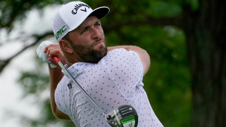 Jon Rahm, of Spain, watches his shot from the 13th tee in the third round at the Northern Trust golf tournament, Saturday, Aug. 21, 2021, at Liberty National Golf Course in Jersey City, N.J. (John Minchillo/AP)