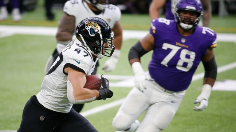 Jacksonville Jaguars linebacker Joe Schobert (47) returns an interception 43-yards for a touchdown during the second half of an NFL football game against the Minnesota Vikings, Sunday, Dec. 6, 2020, in Minneapolis. (Bruce Kluckhohn/AP)