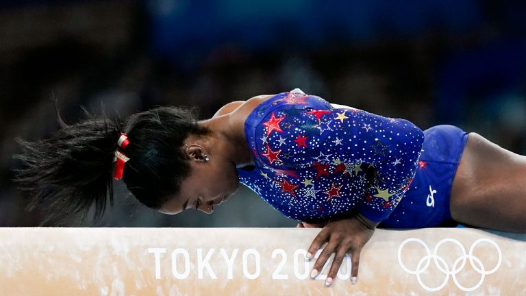 Simone Biles, of the United States, performs on the balance beam during the women's artistic gymnastic qualifications at the 2020 Summer Olympics. (Ashley Landis/AP) 