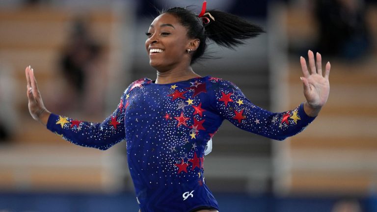 Simone Biles, of the United States, performs on the floor during the women's artistic gymnastic qualifications at the 2020 Summer Olympics. (AP) 