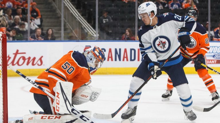 Winnipeg Jets' Jack Roslovic (28) is stopped by Edmonton Oilers' goalie Stuart Skinner (50) during first period NHL preseason action. (Jason Franson/CP)