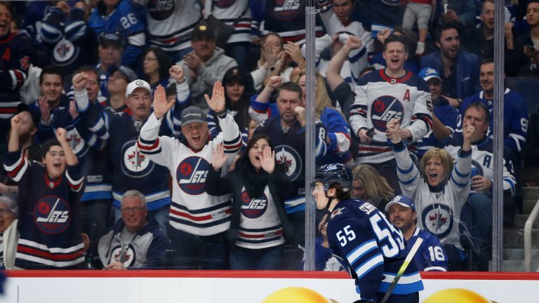 Winnipeg Jets' fans celebrate Mark Scheifele's (55) goal during second period NHL action against the Toronto Maple Leafs, in Winnipeg on Thursday, Jan. 2, 2020. (John Woods/CP) 
