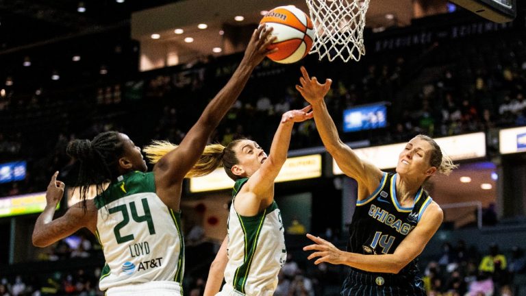 Chicago Sky's Allie Quigley (14) battles for the ball with Seattle's Jewell Loyd, left, and Breanna Stewart, center, in the first quarter of a WNBA basketball game Friday, Aug. 27, 2021, in Everett, Wash. (Dean Rutz/The Seattle Times via AP) 
