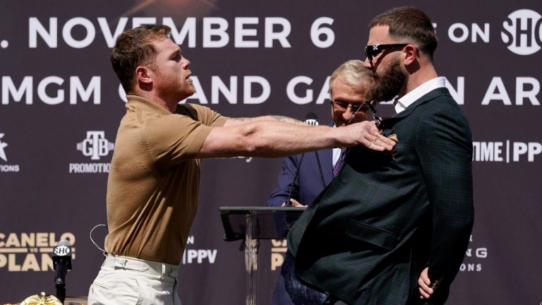 Unified WBC/WBO/WBA super middleweight champion Canelo Alvarez, left, shoves undefeated IBF Super Middleweight Champion Caleb Plant during a news conference. (Mark J. Terrill/AP)