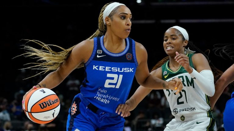 Connecticut Sun guard/forward DiJonai Carrington (21) drives as Seattle Storm guard Jordin Canada defends during the second half of the Commissioner's Cup WNBA basketball game, Thursday, Aug. 12, 2021, in Phoenix (Matt York/AP).
