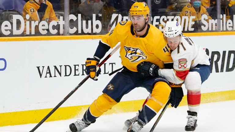 Nashville Predators' Erik Gudbranson (44) keeps Florida Panthers center Lucas Wallmark (71) away from the puck in the third period of an NHL hockey game Monday, April 26, 2021, in Nashville, Tenn (Mark Humphrey/AP).