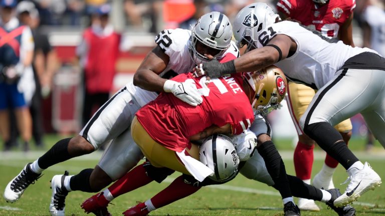 San Francisco 49ers quarterback Trey Lance (5) is tackled by Las Vegas Raiders defensive end Gerri Green, top, cornerback Amik Robertson, bottom, and defensive tackle Gerald McCoy during the first half of an NFL preseason football game in Santa Clara, Calif., Sunday, Aug. 29, 2021 (Tony Avelar/AP).