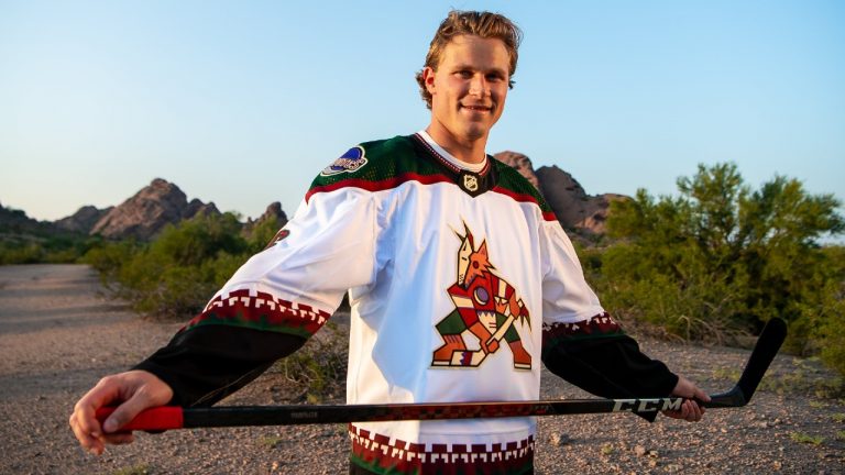 Jakob Chychrun models the Arizona Coyotes' new white Kachina logo uniform. (Photo courtesy: Arizona Coyotes via Twitter)