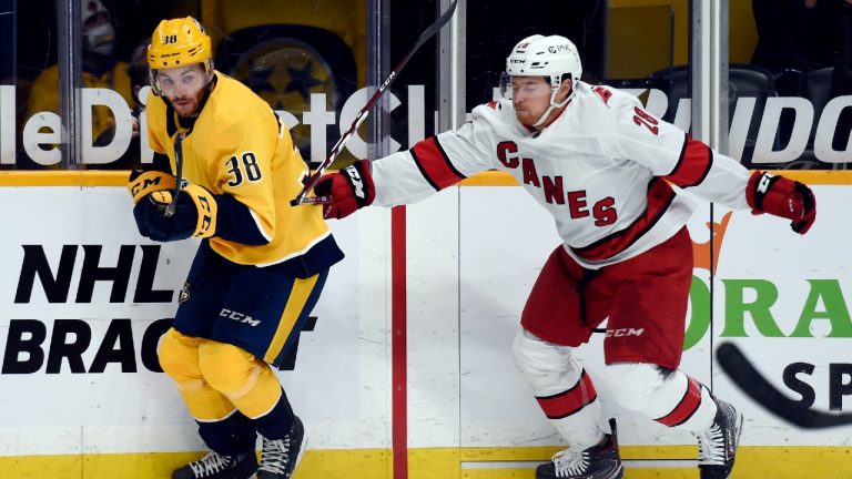 Carolina Hurricanes left wing Max McCormick, right, breaks his stick as he defends against Nashville Predators defenseman Jeremy Davies, left, during the first period of an NHL hockey game Monday, May 10, 2021, in Nashville, Tenn (Mark Zaleski/AP).