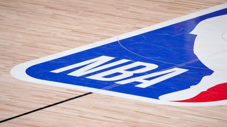 In this Sept. 2, 2020, file photo, the NBA logo is displayed at center court during an NBA first-round playoff basketball game between the Houston Rockets and Oklahoma City Thunder in Lake Buena Vista, Fla (Mark J. Terrill/AP).