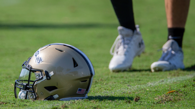 A New Orleans Saints helmet rests on the field during NFL football training camp. (David Grunfeld/AP)