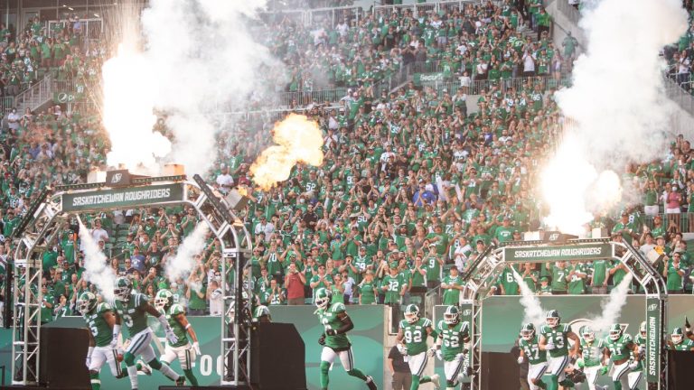 Saskatchewan Roughriders run onto the field in the pregame prior to the first half of CFL football action against the Winnipeg Blue Bombers, in Regina, Sunday, Sept. 5, 2021 (Kayle Neis/CP).