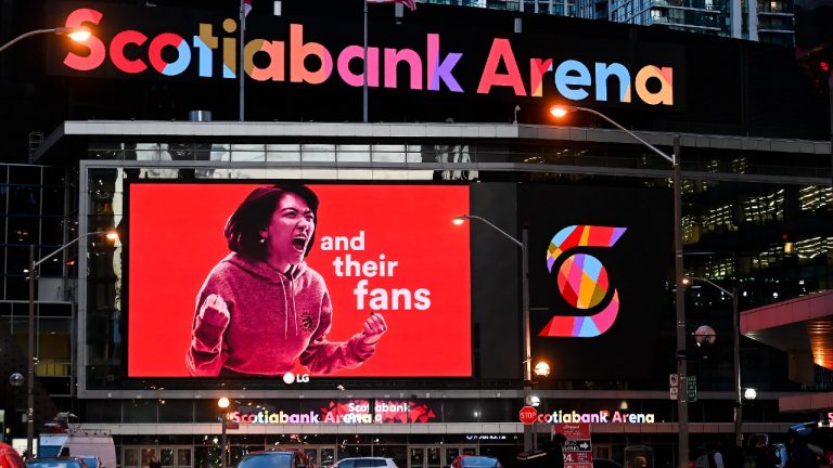 People walk past the Scotiabank Arena, where the Toronto Raptors and the Toronto Maple Leafs play, in Toronto, Friday, Nov. 20, 2020 (Nathan Denette/CP).