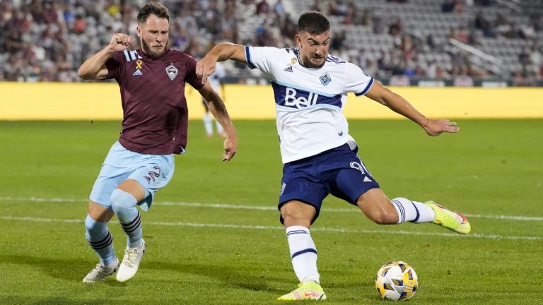 Vancouver Whitecaps forward Lucas Cavallini, right, takes a shot on the goal as Colorado Rapids defender Keegan Rosenberry covers in the second half of an MLS soccer match Sunday, Sept. 19, 2021, in Commerce City, Colo. (David Zalubowski/AP).