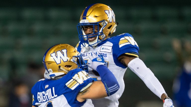 Winnipeg Blue Bombers' Adam Bighill (4) and DeAundre Alford (45) celebrate a touchdown against the Edmonton Elks during second half CFL action in Edmonton, Alta., on Saturday, Sept. 18, 2021. (Jason Franson/CP)