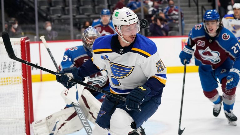 The puck flies in front of St. Louis Blues centre Tyler Bozak as Colorado Avalanche goaltender Philipp Grubauer, back left, and defenceman Ryan Graves watch during the third period of Game 2 of an NHL hockey Stanley Cup first-round playoff series Wednesday, May 19, 2021, in Denver. Colorado won 6-3. (David Zalubowski/AP)