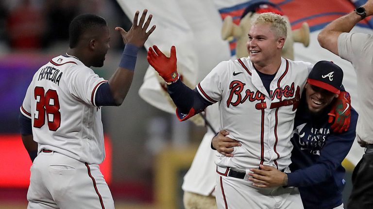 Atlanta Braves' Joc Pederson, center, celebrates with Guillermo Heredia (38) after driving in the winning run against the Washington Nationals in the 10th inning of a baseball game. (Ben Margot/AP) 