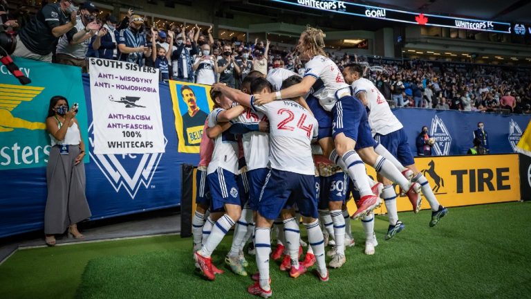 Vancouver Whitecaps' Deiber Caicedo is mobbed by his teammates after scoring against Austin FC during the second half of an MLS soccer game in Vancouver, on Saturday, September 4, 2021. (Darryl Dyck/CP)