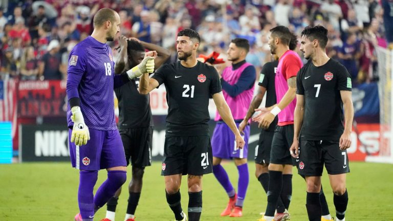 Canada goalkeeper Milan Borjan (18) bumps fists with midfielder Jonathan Osorio (21) as they leave the pitch following a 1-1 draw with the United States in a World Cup soccer qualifier. (Mark Humphrey/AP)