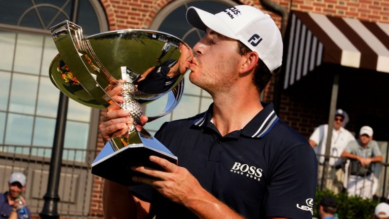 Patrick Cantlay kisses the trophy after winning the Tour Championship golf tournament and the FedEx Cup at East Lake Golf Club. (Brynn Anderson/AP) 