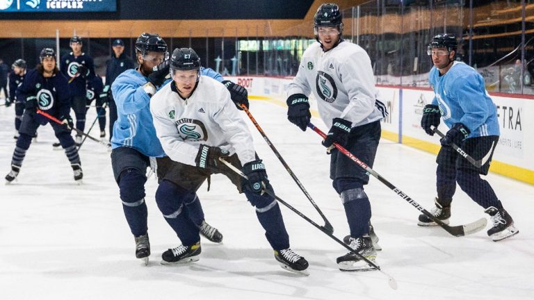 Seattle Kraken players Dennis Cholowski (27) protects the puck from Adam Larsson (6) during NHL hockey training camp at Kraken Community Iceplex on Thursday, Sept. 23, 2021, in Seattle. (Amanda Snyder/The Seattle Times via AP)