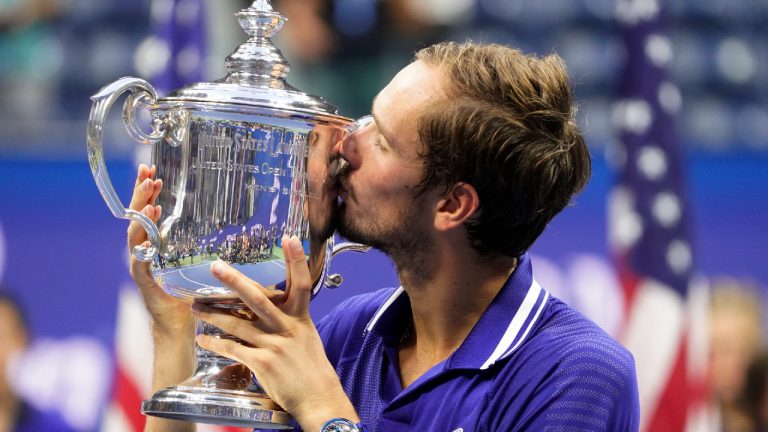 Daniil Medvedev, of Russia, kisses the championship trophy after defeating Novak Djokovic, of Serbia, in the men's singles final of the US Open tennis championships, Sunday, Sept. 12, 2021, in New York. (John Minchillo/AP) 
