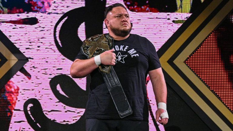 WWE superstar Samoa Joe walks down the ramp with the NXT Championship. (Photo by WWE)