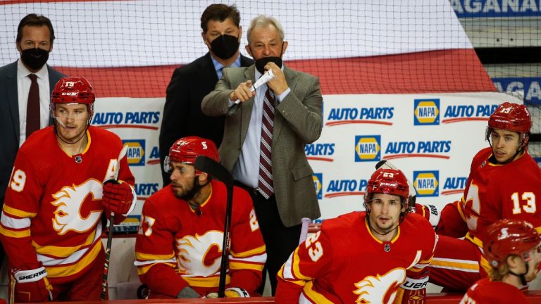 Calgary Flames head coach Darryl Sutter, centre, directs his team during first period NHL hockey action against the Winnipeg Jets in Calgary, Monday, March 29, 2021. (Jeff McIntosh/CP)