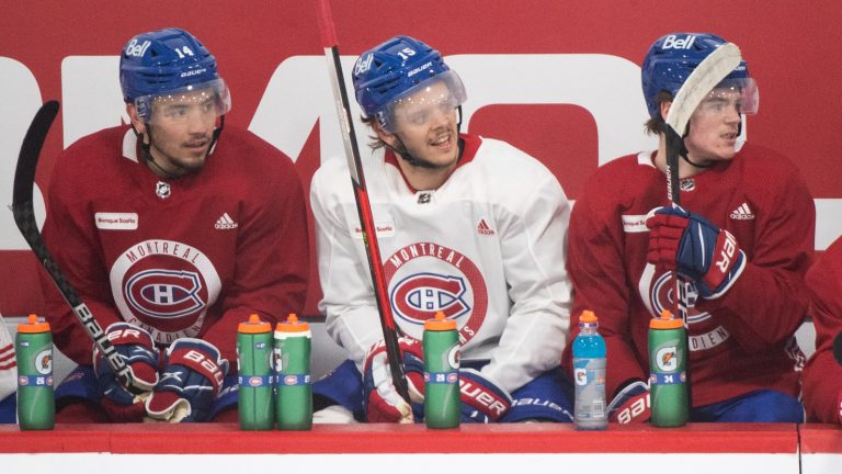 Montreal Canadiens' Nick Suzuki (14), Jesperi Kotkaniemi (15) and Cole Caufield (22) look on from the bench during practice in Brossard, Que., south of Montreal, Sunday, June 27, 2021, ahead of departure to Florida to take on the Tampa Bay Lightning in game one of the Stanley Cup final on Monday June 28. (Graham Hughes/CP)