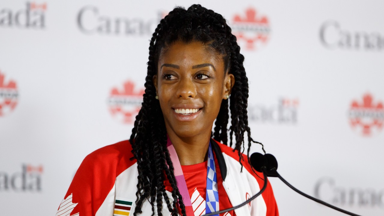 Canadian soccer star Ashley Lawrence smiles at a press conference at BMO Field in Toronto. (Cole Burston/CP)