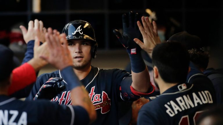 Atlanta Braves' Austin Riley celebrates in the dugout after a home run against the Milwaukee Brewers during the sixth inning in Game 2 of baseball's National League Divisional Series Saturday, Oct. 9, 2021, in Milwaukee (Aaron Gash/AP).