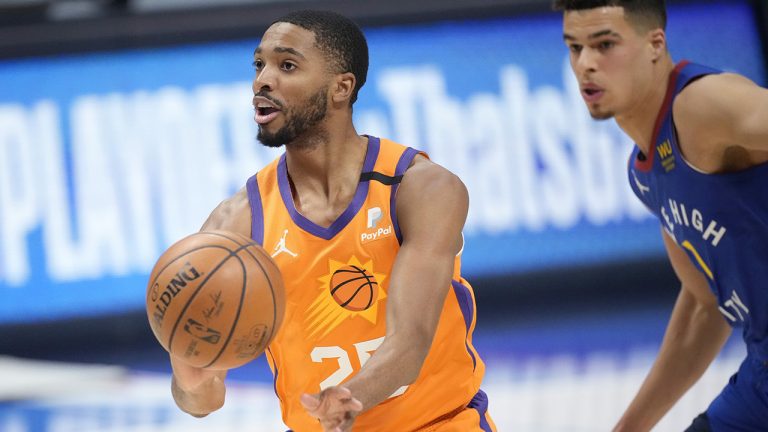 Phoenix Suns forward Mikal Bridges, left, drives past Denver Nuggets forward Michael Porter Jr. in the first half of Game 3 of an NBA second-round playoff series. (David Zalubowski/AP)