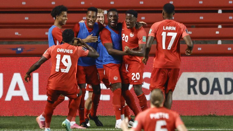 Canada's Jonathan David (20) celebrates with teammates after scoring a goal against Suriname. (Kamil Krzaczynski/AP)