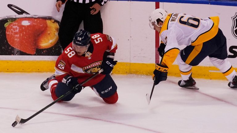 Noah Juulsen (58), pictured as a member of the Florida Panthers, passes the puck as Nashville Predators center Grant Mismash (62) defends, during the first period at an NHL preseason second doubleheader hockey game, Sunday, Sept. 26, 2021, in Sunrise, Fla. (Marta Lavandier/AP) 