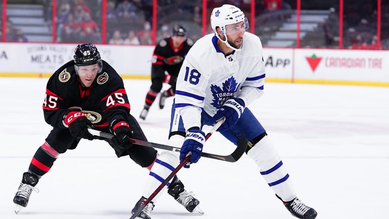 Toronto Maple Leafs' Michael Amadio (18) moves the puck as Ottawa Senators centre Parker Kelly (45) defends during first period pre-season NHL action in Ottawa on Wednesday, Sept. 29, 2021. (Sean Kilpatrick/CP)