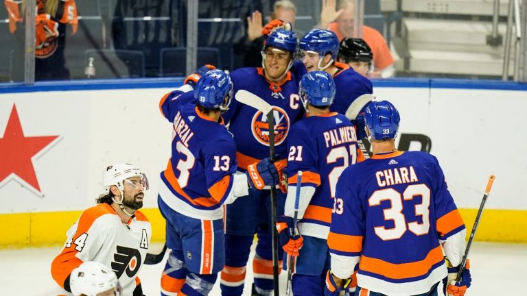 Philadelphia Flyers' Nate Thomposon skates past New York Islanders' Anders Lee as he celebrates with teammates after scoring a goal during the first period of a NHL preseason hockey game Tuesday, Oct. 5, 2021, in Bridgeport, Conn. (Frank Franklin II/AP Photo) 