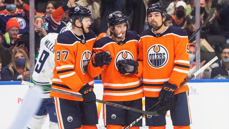 Edmonton Oilers' Warren Foegele (37), Derek Ryan (10) and Cody Ceci (5) celebrate a goal against there Vancouver Canucks during second period NHL pre-season action in Edmonton on Thursday, October 7, 2021. (Jason Franson/CP)