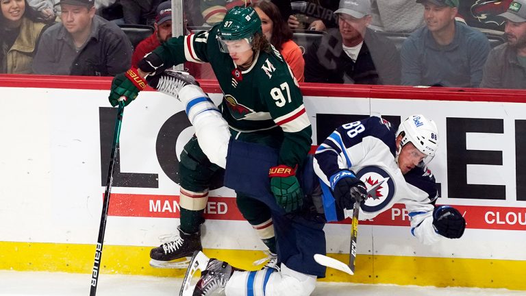 Minnesota Wild's Kirill Kaprizov (97) sends Winnipeg Jets' Nate Schmidt (88) to the ice during the first period of an NHL hockey game Tuesday, Oct. 19, 2021, in St. Paul, Minn. (Jim Mone/AP)