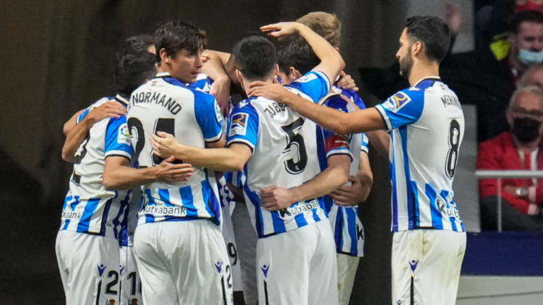 Real Sociedad, seen here celebrating during Sunday's game, are unbeaten in 10 straight league matches. (AP)