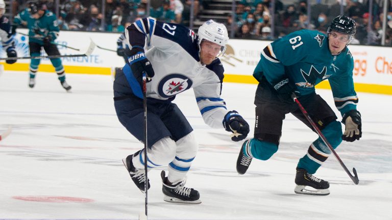 Winnipeg Jets left wing Nikolaj Ehlers (27) tries to make a fast break ahead of San Jose Sharks defenceman Santeri Hatakka (61) during the second period of an NHL hockey game Saturday, Oct. 30, 2021, in San Jose, Calif. (D. Ross Cameron/AP)