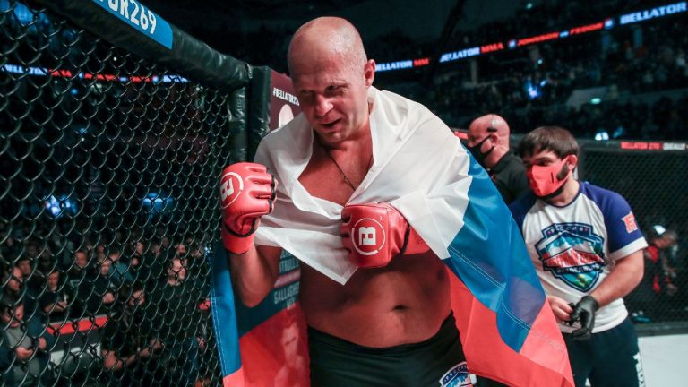 Mixed martial arts legend Fedor Emelianenko with a Russian flag draped over his shoulders as he celebrates a knockout win over Tim Johnson at Bellator 269 in Moscow. (Lucas Noonan/Bellator MMA)