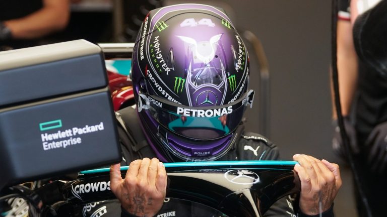 Mercedes driver Lewis Hamilton, of Britain, climbs into his car for a practice session for the F1 US Grand Prix auto race at the Circuit of the Americas, Friday, Oct. 22, 2021, in Austin, Texas. (Darron Cummings/AP Photo) 
