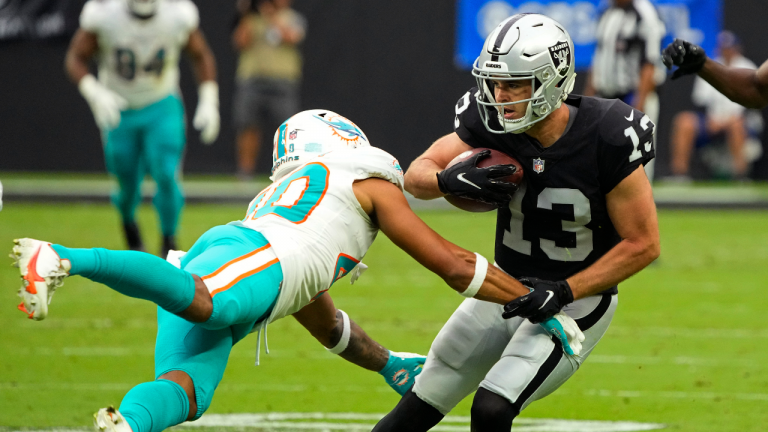 Miami Dolphins defensive back Nik Needham (40) attempts to tackle Las Vegas Raiders wide receiver Hunter Renfrow (13) during the first half of an NFL football game, Sunday, Sept. 26, 2021, in Las Vegas. (Rick Scuteri/AP) 