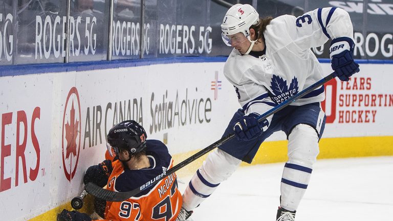 Edmonton Oilers' Connor McDavid (97) is checked by Toronto Maple Leafs' Justin Holl (3) during second period NHL action in Edmonton. (Jason Franson/CP)