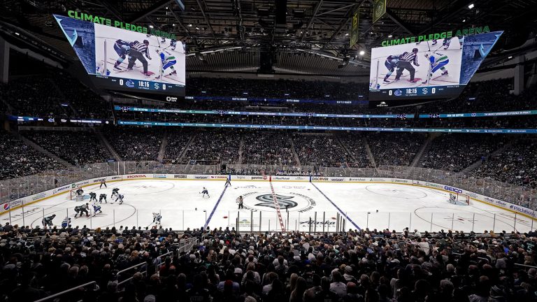 The Seattle Kraken and the Vancouver Canucks play during the first period of an NHL hockey game Saturday, Oct. 23, 2021, in Seattle, in the expansion team's home-opener. (Elaine Thompson/AP)