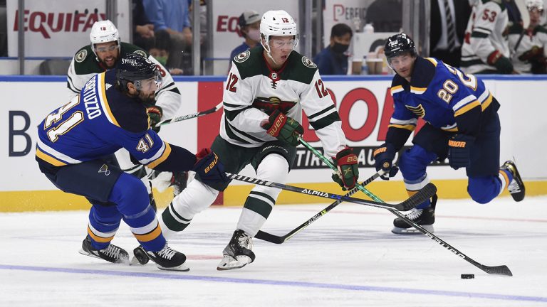 St. Louis Blues' Robert Bortuzzo (41) battles Minnesota Wild's Matthew Boldy (12) for the puck during the first period of a preseason NHL hockey game Saturday, Sept. 25, 2021, in St. Louis. (Joe Puetz/AP)